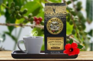 A display of Royal Kona Coffee's 100% Kona retail bag with a mug of hot coffee.