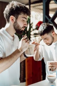 Two men tasting coffee in a cozy Baku café, enjoying the rich aroma and flavor.